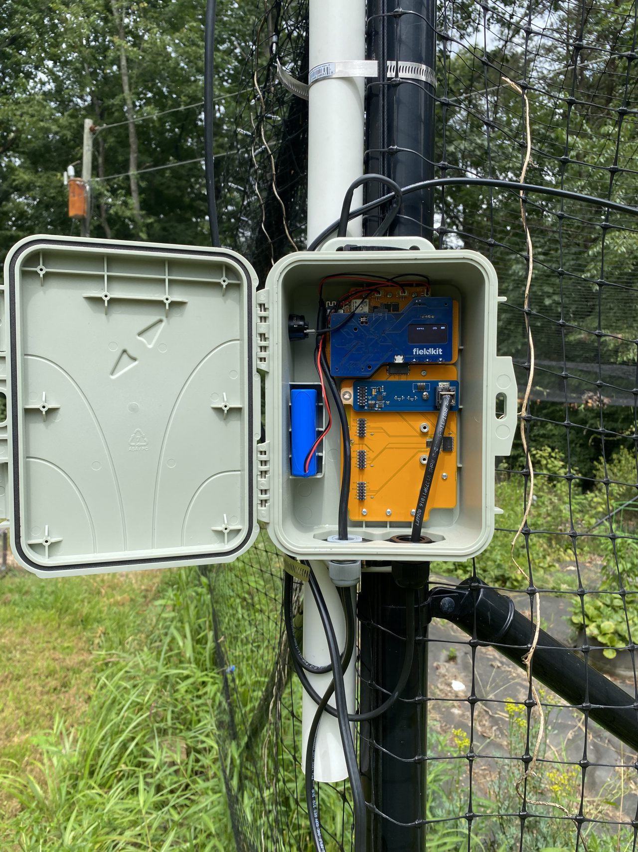 Station mounted with heavy-duty zip ties on fence post and PVC combo